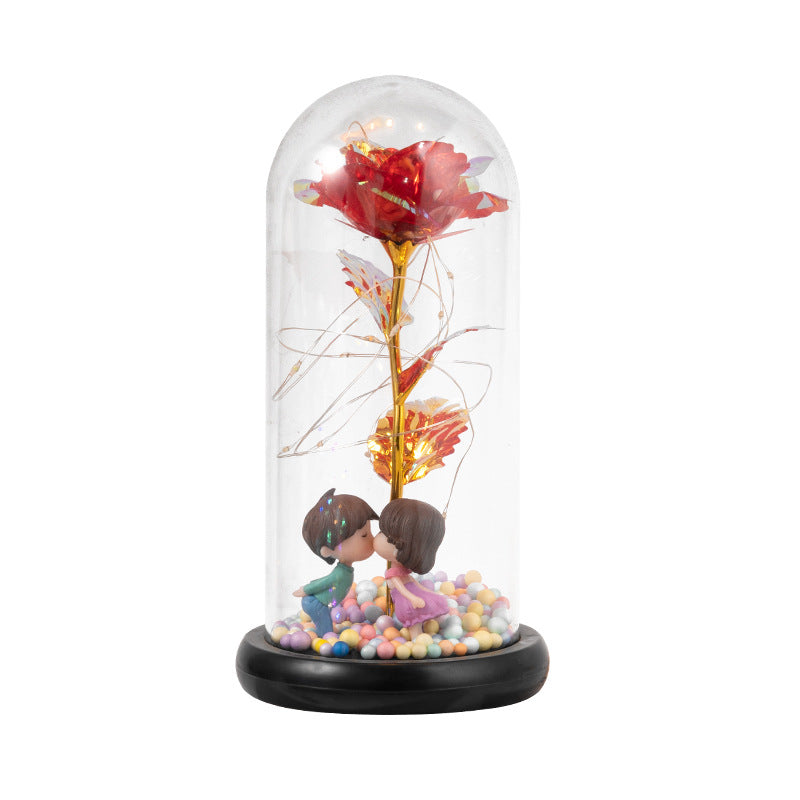 Rose under glasskuppel med lys